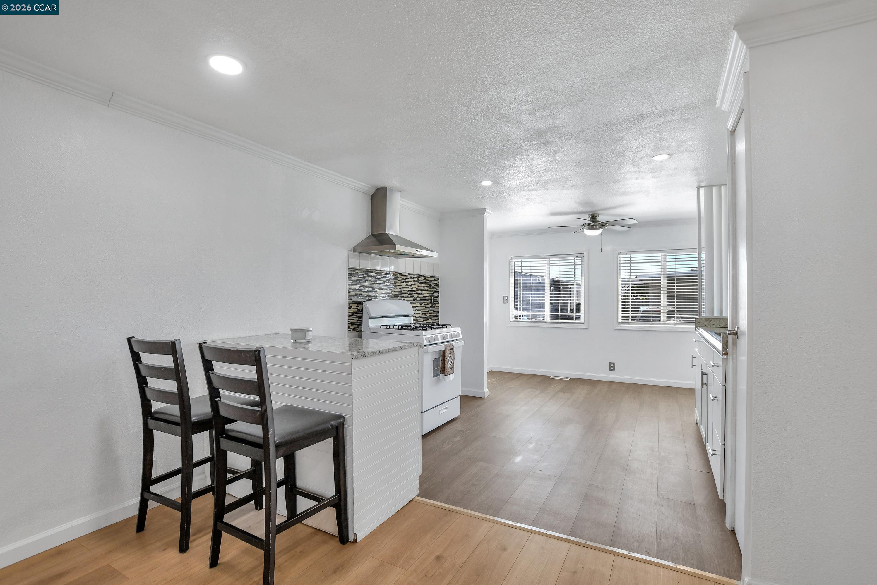 237 Orangevale Pittsburg, CA 94565 - Photo 5 of 21 a kitchen with a table chairs stove and cabinets