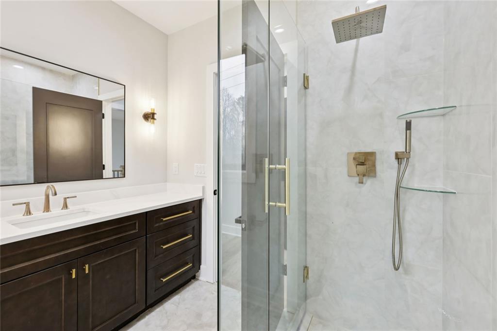 24 Rocking Wood Drive Auburn, GA 30011 - Photo 62 of 101 a bathroom with a double vanity sink mirror and shower