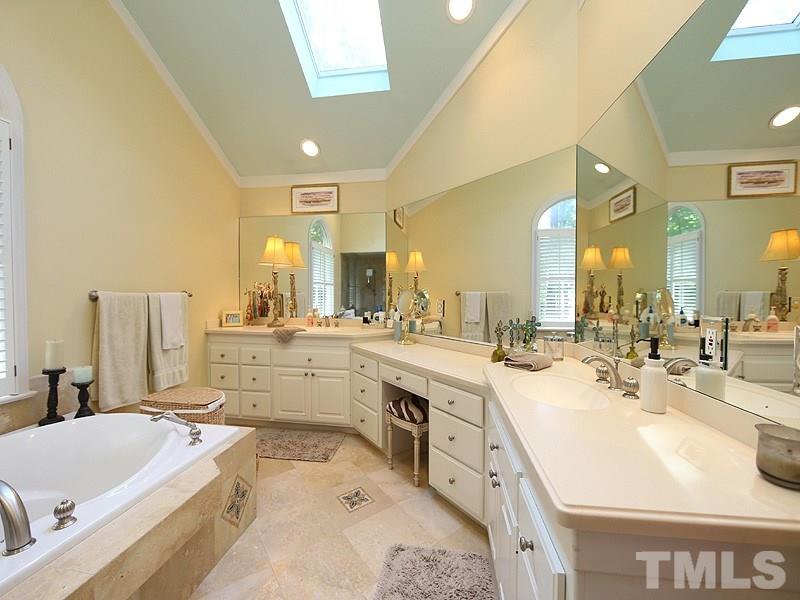 600 Marlowe Road Raleigh, NC 27609 - Photo 11 of 18 a large bathroom with a double vanity sink mirror and bathtub