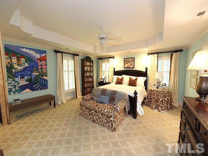 600 Marlowe Road Raleigh, NC 27609 - Photo 10 of 18 a bedroom with a large bed and a flat tv screen on dresser