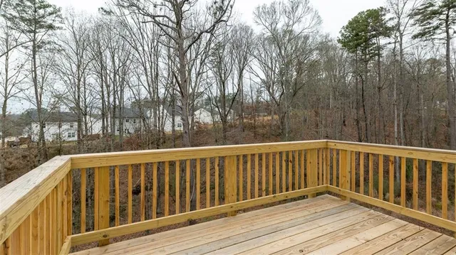 a view of wooden deck and trees