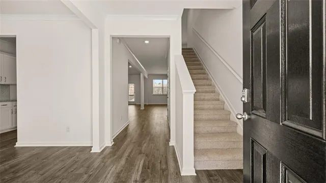 a view of a hallway with wooden floor and entryway