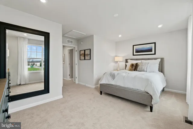 a bedroom with a bed and a painting