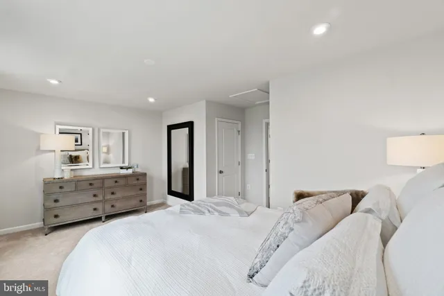 a bedroom with a bed and dresser