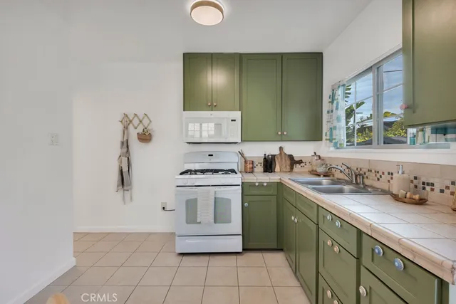 a dining room with furniture and potted plants