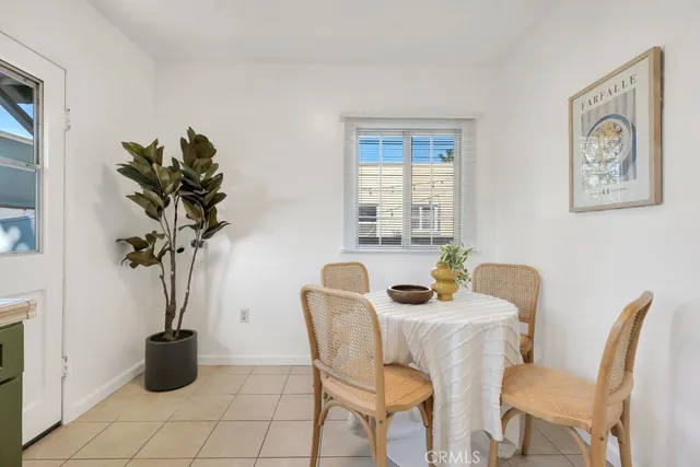 a bedroom with a bed and a potted plant