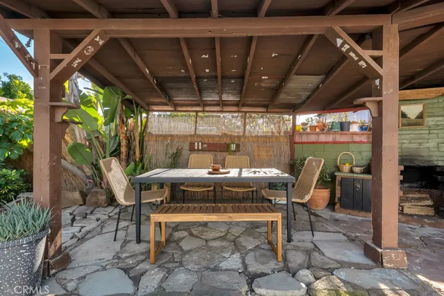 a patio with a table and chairs