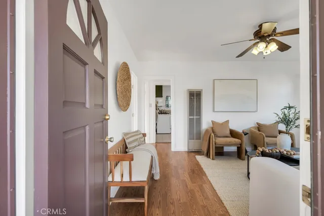 a living room with furniture chandelier and a window
