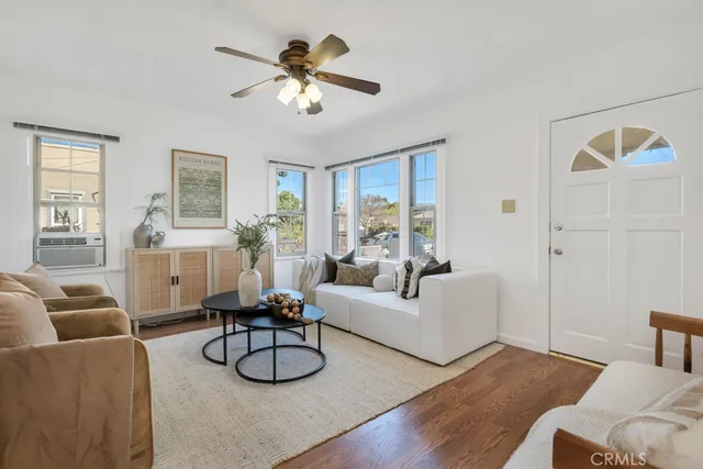 a living room with furniture and a wall painting