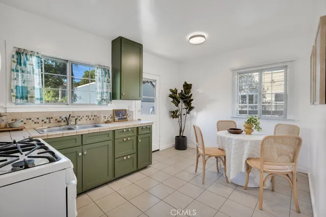 a kitchen with a sink cabinets and window