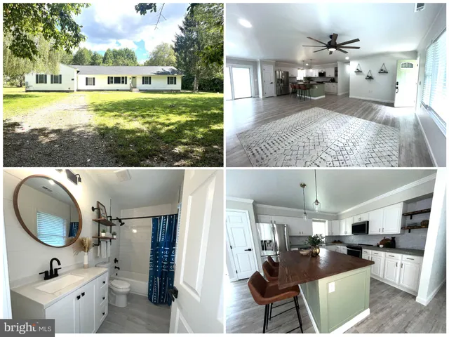 a view of a house with a big yard and large trees
