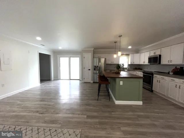 a view of kitchen island with wooden floor