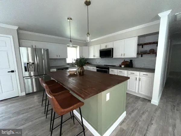 a kitchen with granite countertop white cabinets and white appliances