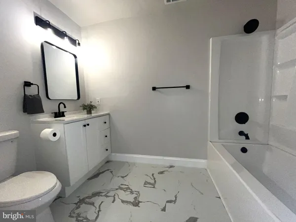 a view of a livingroom with a hardwood floor and a ceiling fan
