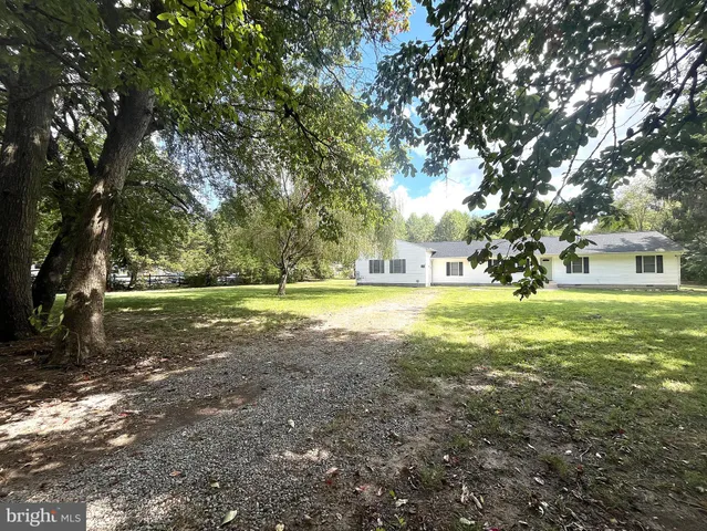 a view of a room with wooden floor and windows