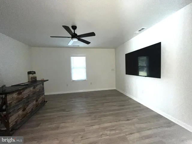 a bathroom with a sink a mirror a vanity and a shower