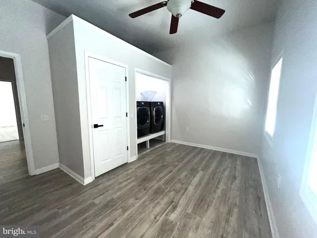 a view of a lake with lawn chairs under an umbrella