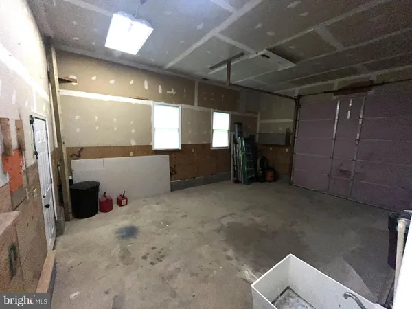 an aerial view of a swimming pool with lawn chairs and a big yard