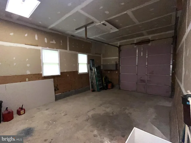 a front view of a house with garden and trees