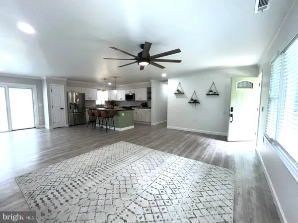 a kitchen with stainless steel appliances granite countertop a refrigerator stove top oven and cabinets