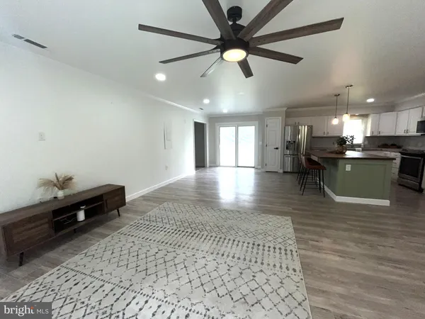 a kitchen with a sink cabinets and wooden floor