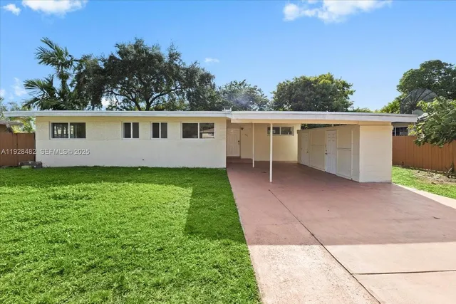 a view of house with backyard and garden