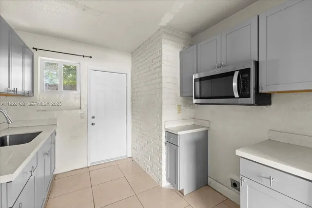 a kitchen with a sink stove and microwave