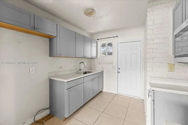 a kitchen with a sink cabinets and appliances