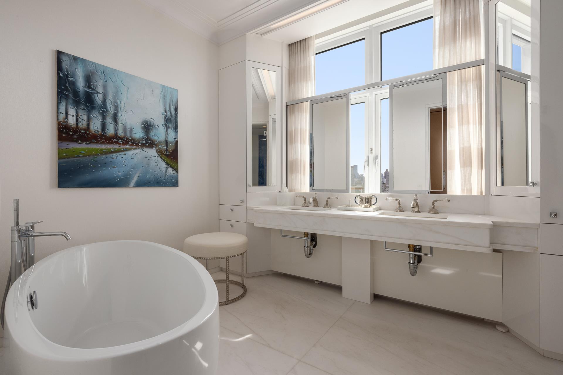 535 West End Avenue, Unit PH Manhattan, NY 10024 - Photo 12 of 19 a bathroom with a double vanity sink a mirror and a bathtub