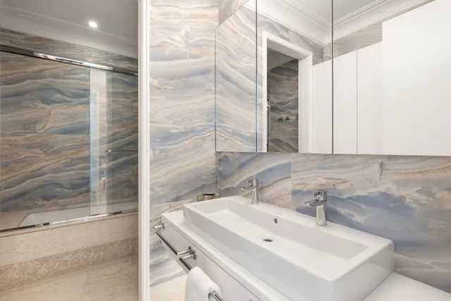 a bed room with a bed and a chandelier