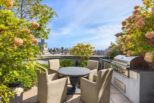 a terrace with outdoor seating and city view
