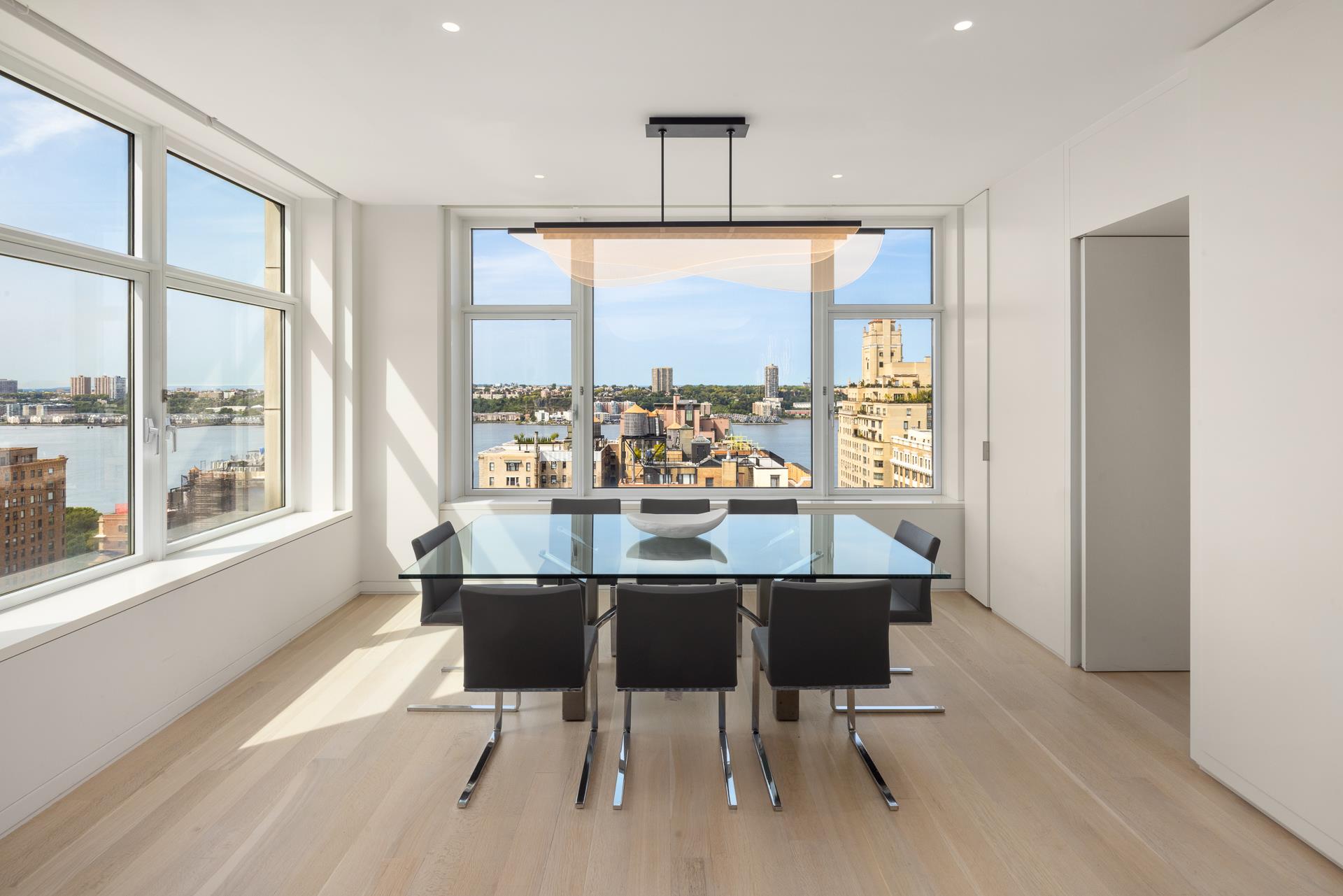535 West End Avenue, Unit PH Manhattan, NY 10024 - Photo 7 of 19 a dining room with furniture a chandelier and wooden floor