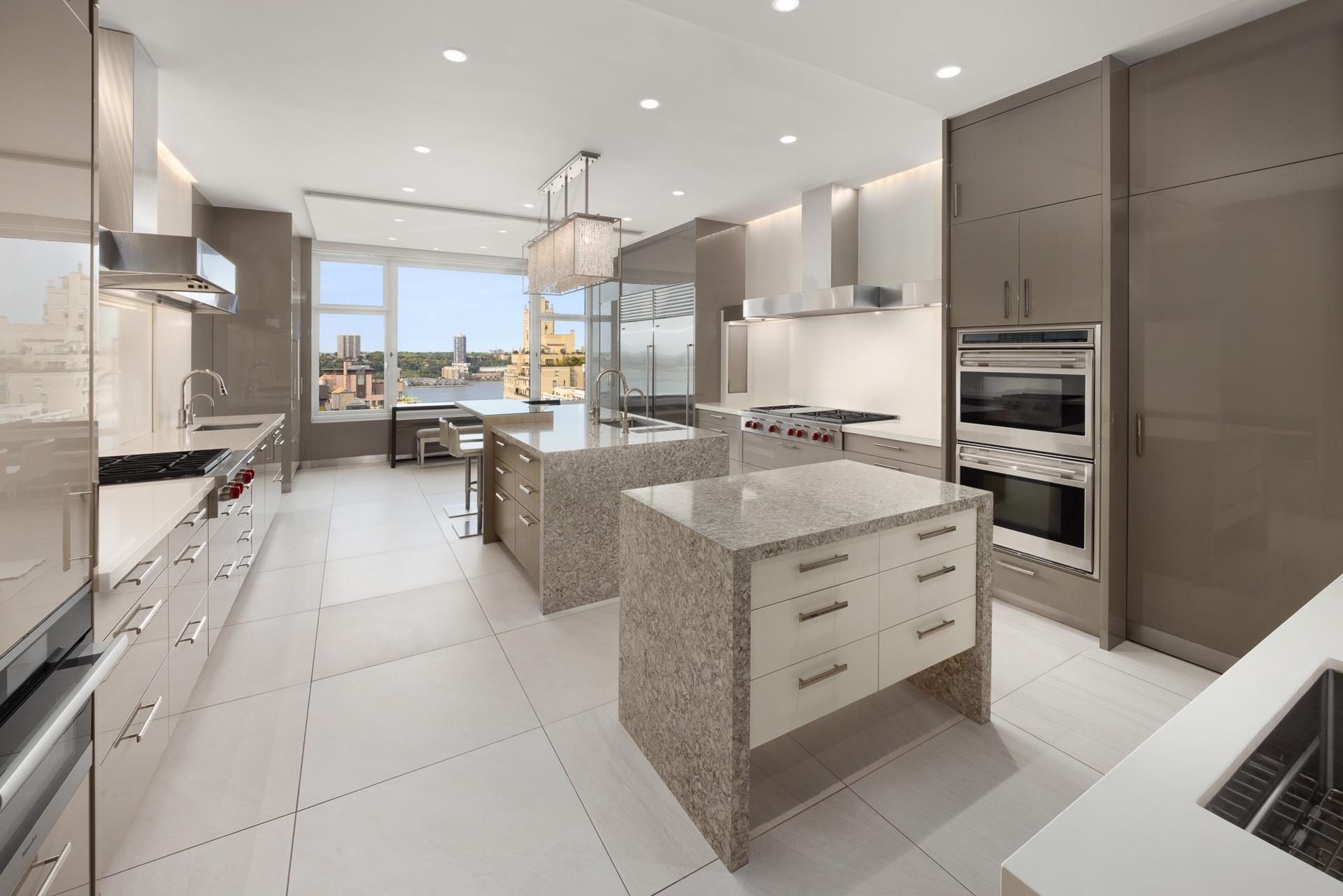 535 West End Avenue, Unit PH Manhattan, NY 10024 - Photo 8 of 19 a kitchen with stainless steel appliances kitchen island granite countertop a sink and cabinets