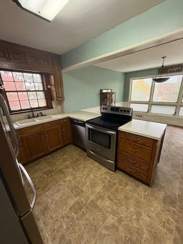 a kitchen with granite countertop a sink and a stove top oven
