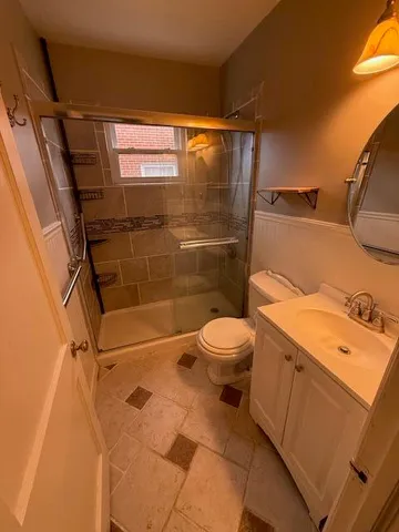 a bathroom with a toilet and a shower