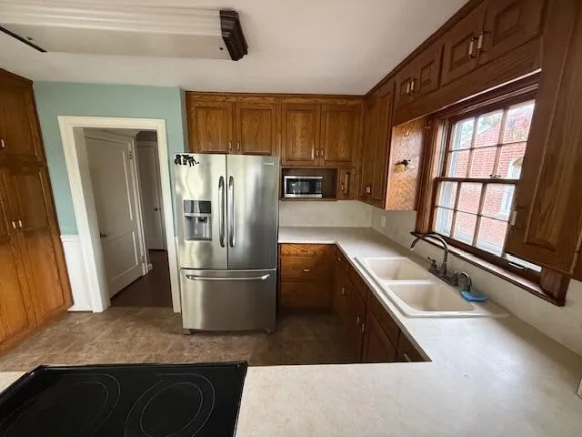 a kitchen with a refrigerator and a sink