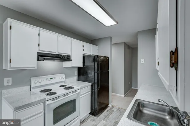 a kitchen with a stove and a refrigerator