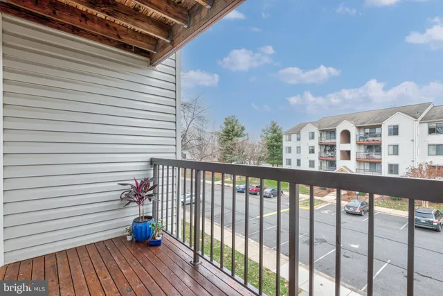 a view of a balcony with wooden fence