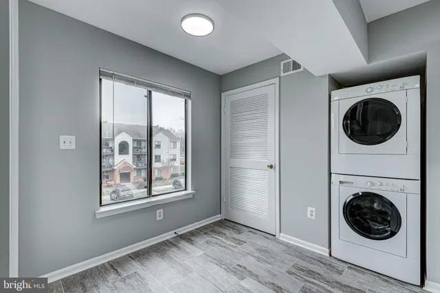 a view of a hallway with washer and dryer