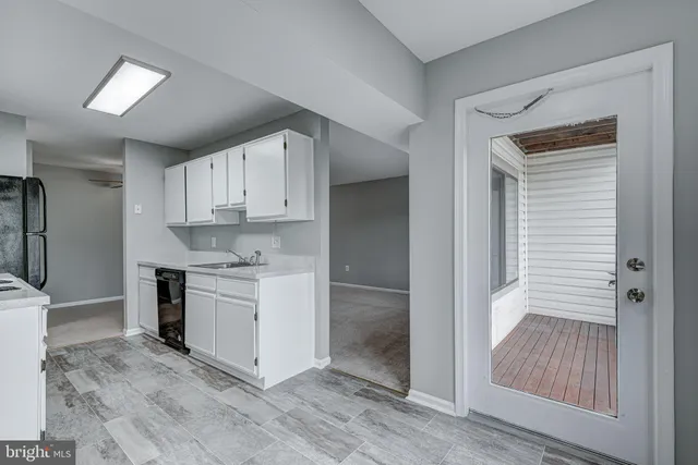 a kitchen with white cabinets and white appliances