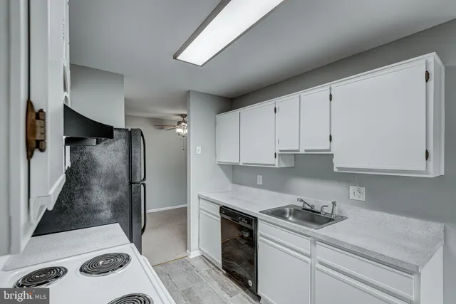 a kitchen with a sink stainless steel appliances and cabinets