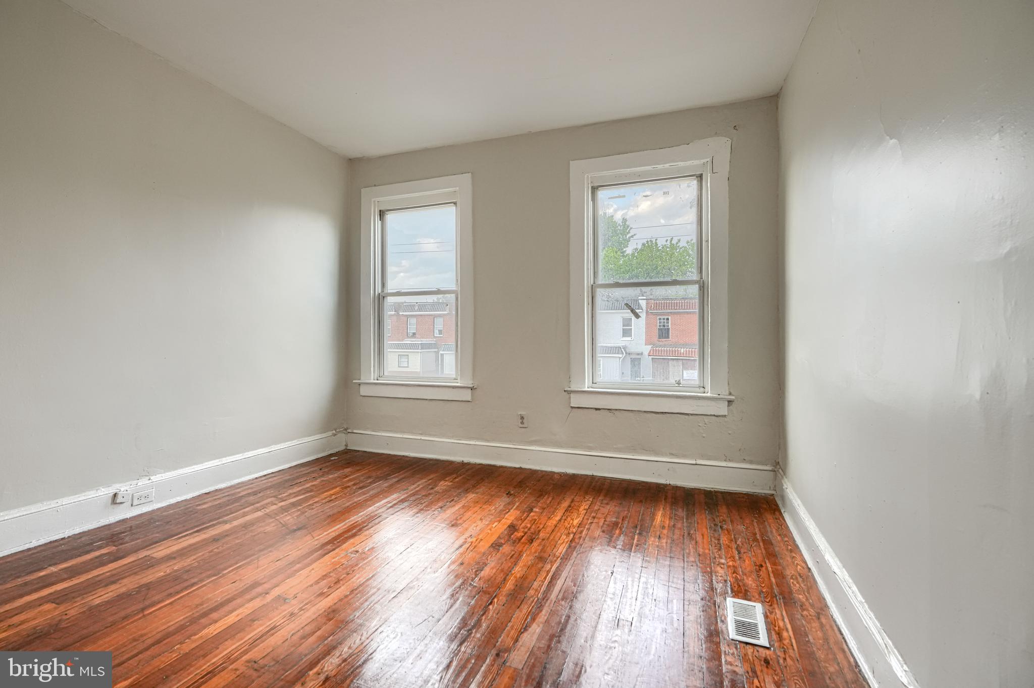 4806 Reisterstown Road Baltimore, MD 21215 - Photo 19 of 34 wooden floor in an empty room with a window