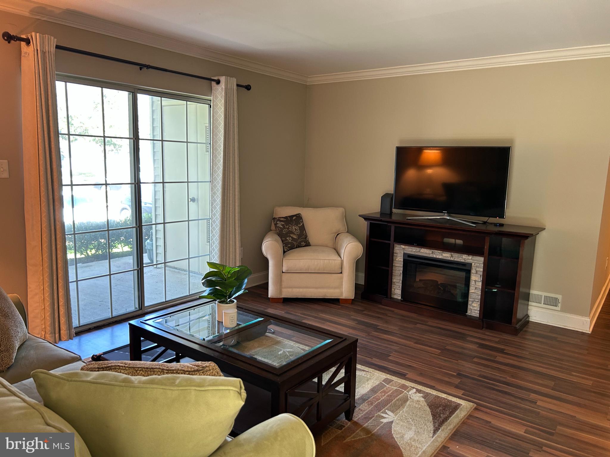907 A Oliphant Lane Mount Laurel, NJ 08054 - Photo 5 of 23 a living room with furniture a flat screen tv and a fireplace