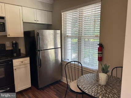 a kitchen with a refrigerator stove and microwave