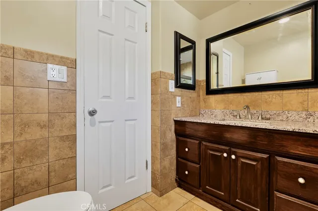 a bathroom with a sink a toilet and mirror