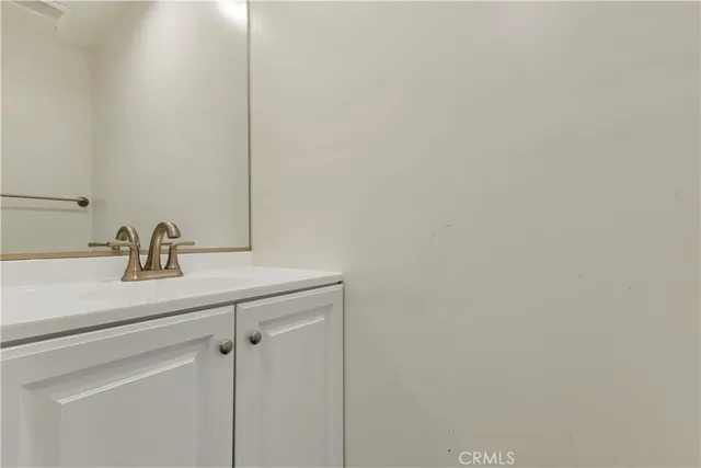 a bathroom with a sink and vanity
