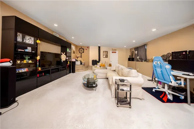 a living room with lots of furniture and kitchen view
