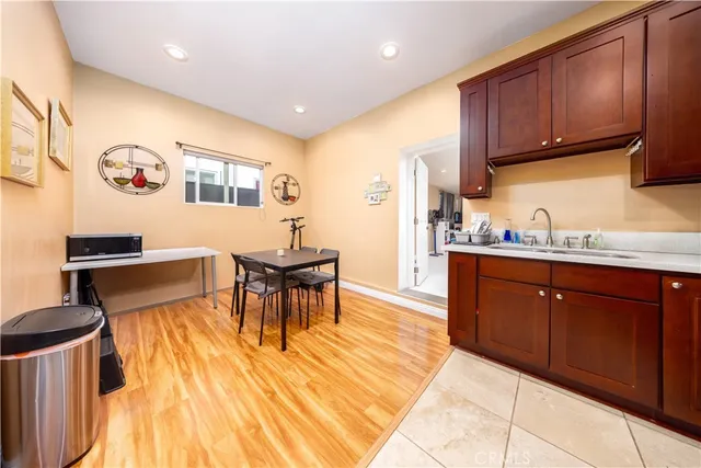 a kitchen with stainless steel appliances granite countertop a sink dishwasher and cabinets with wooden floor