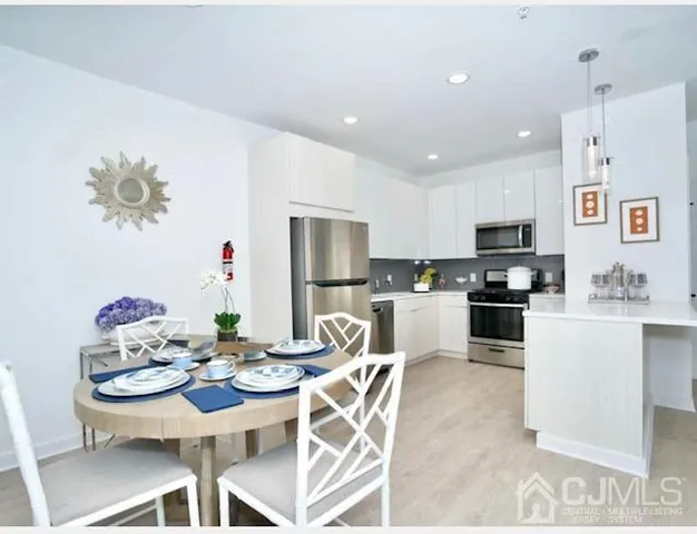 a kitchen with stainless steel appliances kitchen island granite countertop a sink and cabinets