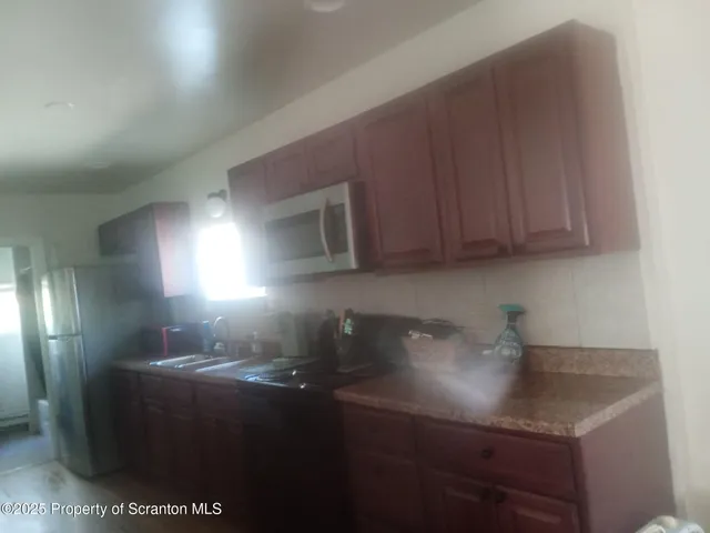 a kitchen with a sink cabinets and utility